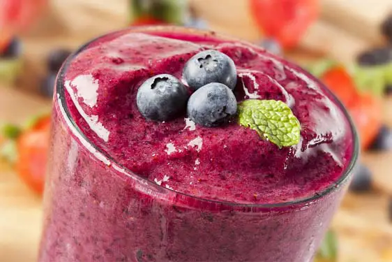 Closeup of frozen fruit smoothie topped with blueberries.