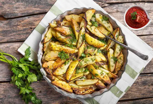 Top view of delicious homemade French fries on a plate.