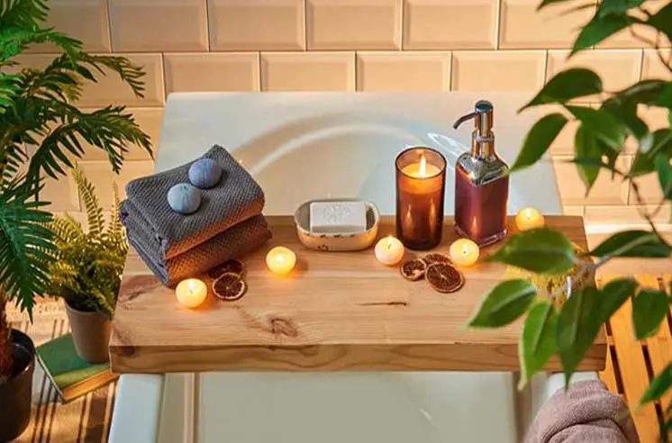 Beautiful bathtub with candles and spa accessories.