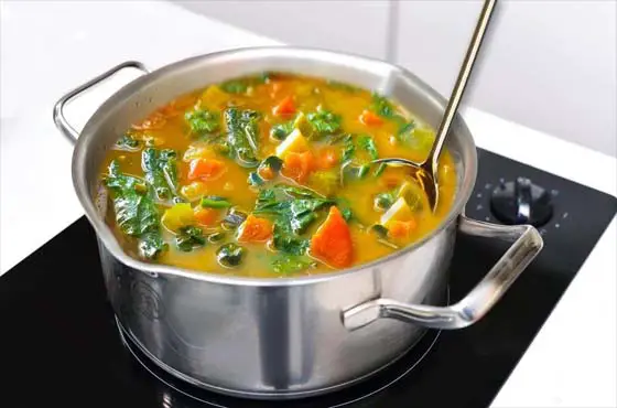 Pot of vegetable soup on the stove. 