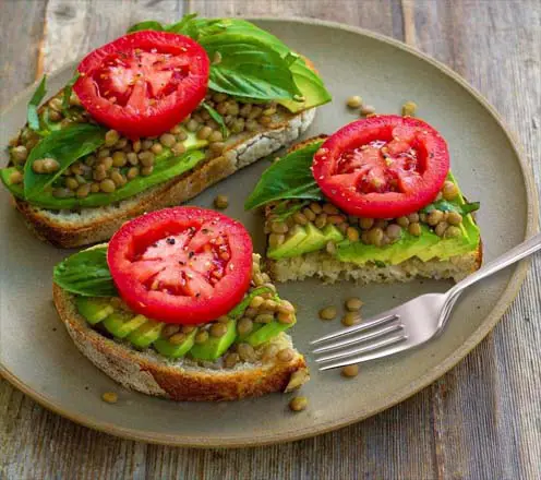 Avocado toast & open-faced sandwich with lentils, tomatoes, & greens. 