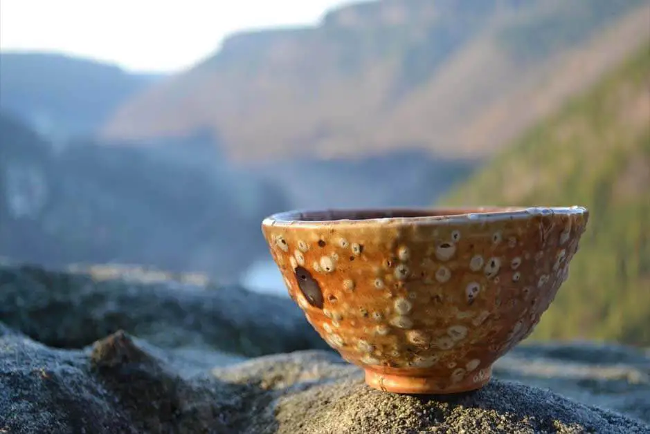 An empty artisan bowl on a mountain ledge. 