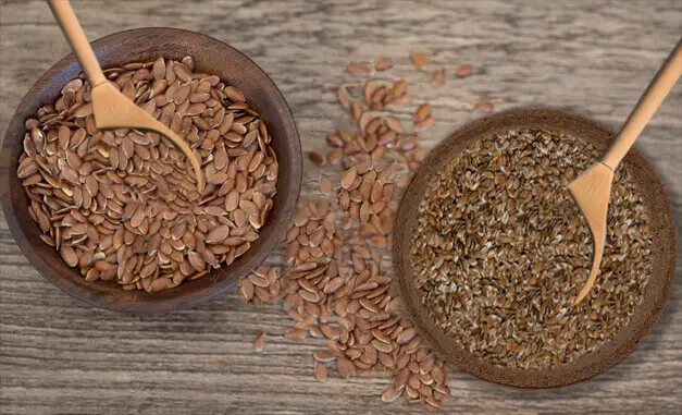 Bowls of flax seed on a board. 