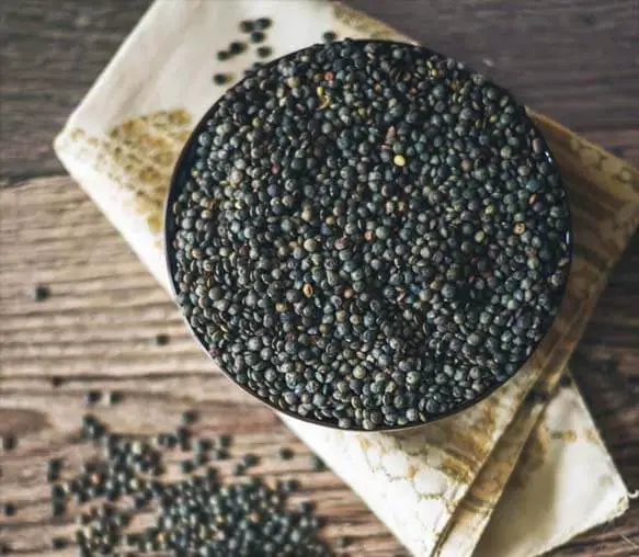 Bowl of lentils on a rustic board. 