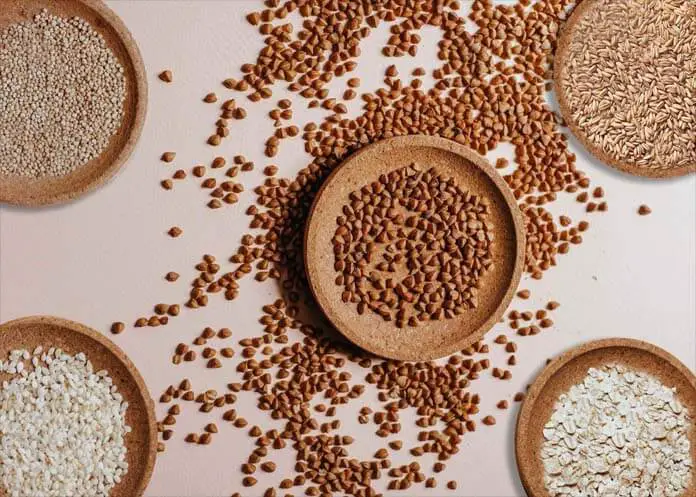 Top view of raw grains in wooden bowls. 