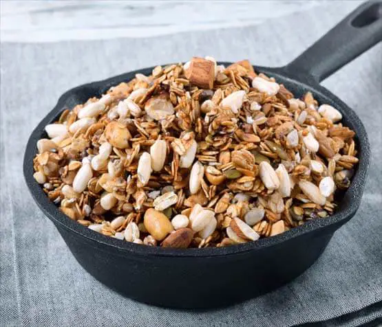 Closeup of homemade granola in a cast iron pan. 