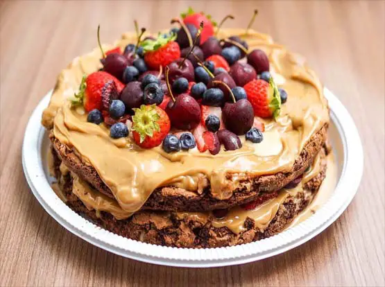 Homemade pancakes with peanut butter, cacao chips, and fruit.