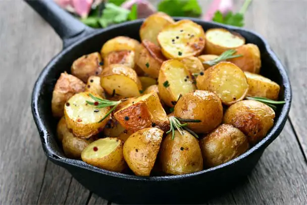 Herbed homemade baked potatoes in cast iron. 