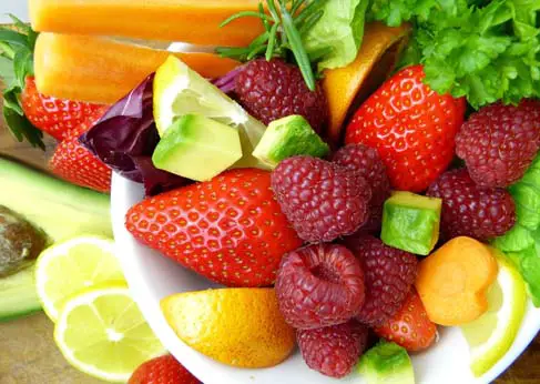 Close-up of high-fiber fruits including strawberries, raspberries, avocado, and more. 