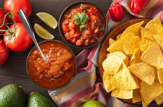 Top view of fresh homemade salsa and chips.