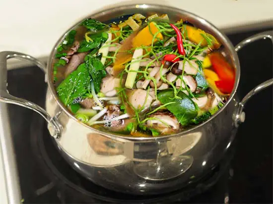 Full pot of plant-based bone broth on the stove.