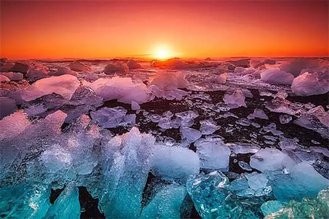 Sweeping view of a gorgeous sunset across an icy sea suggests cold shock protein benefits.