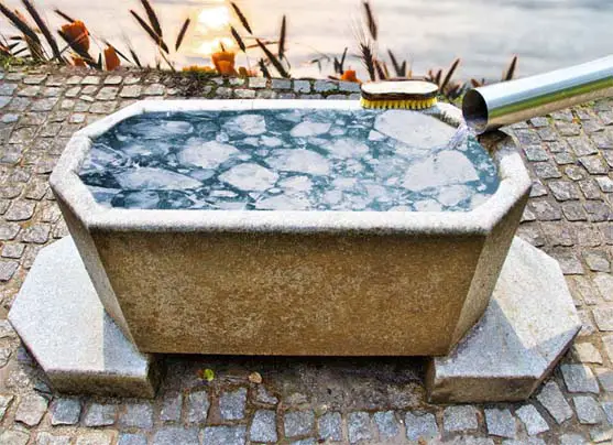 An outdoor ice bath up on blocks.  