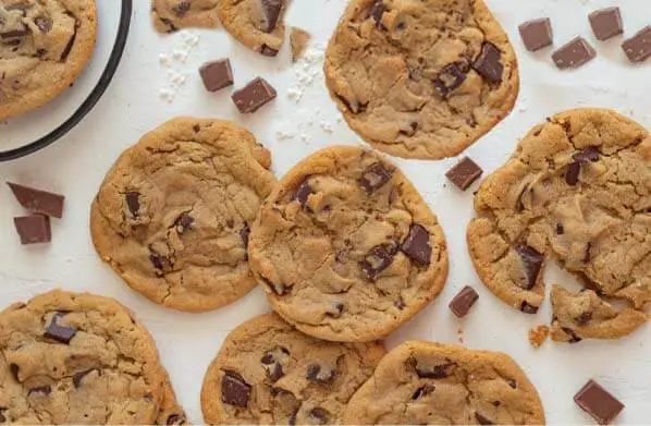 Top view of Himalayan Tartary Buckwheat chocolate chip cookies and chocolate chunks on a board.  