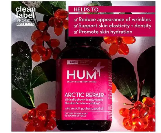 Hum Nutrition Arctic Repair supplement surrounded by lingonberries and green leaves featuring wild lingonberry seed oil for skin. 