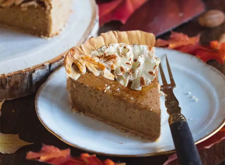 Rich slice of vegan Himalayan Tartary Buckwheat pumpkin pie with whipped topping.