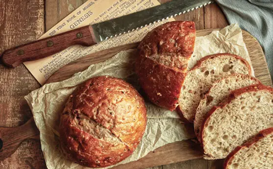 Top view of rich Himalayan Tartary Buckwheat sourdough bread loaves on a rustic board.