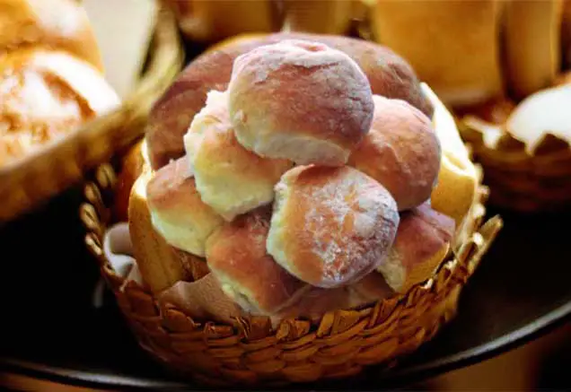 A wicker basket stacked with buttery rich Himalayan Tartary Buckwheat dinner rolls.