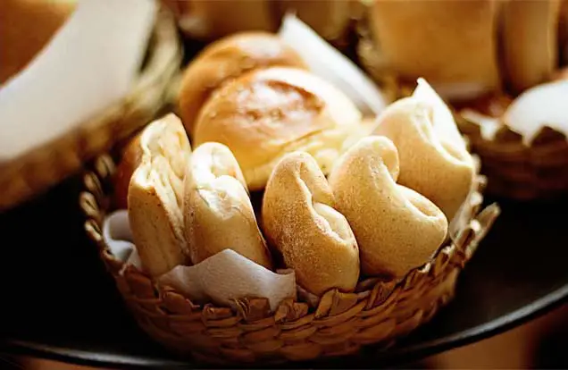 A wicker basket of buttery rich Himalayan Tartary Buckwheat dinner rolls on a table. 