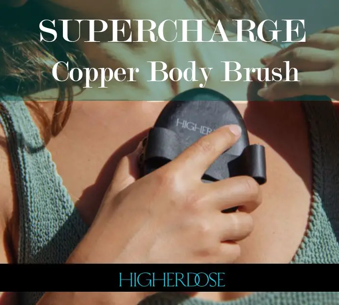 A clickable image showing a girl holding a Higher Dose Supercharge Copper Body Brush against her chest. 