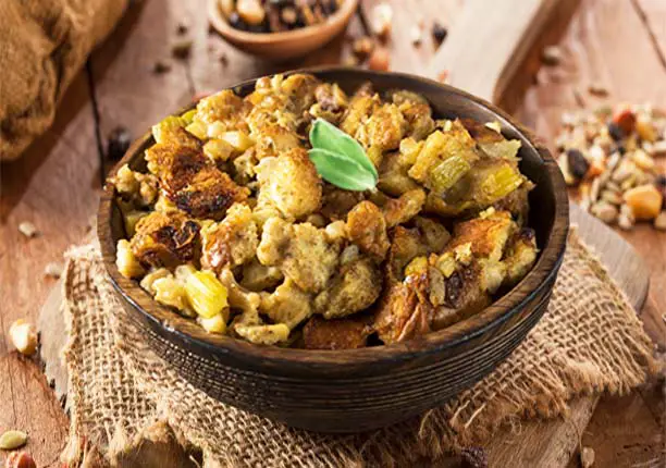 Delicious vegan/vegetarian stuffing with Himalayan Tartary Buckwheat in a bowl on a wooden cutting board.