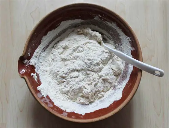 Top view of granular biscuit dough in a ceramic bowl.  