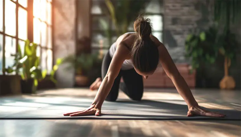 A woman doing yoga and strength training exercises on a mat.